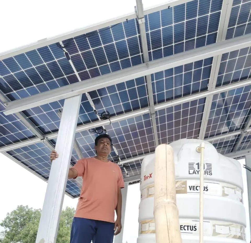 Technician carrying a solar module on site